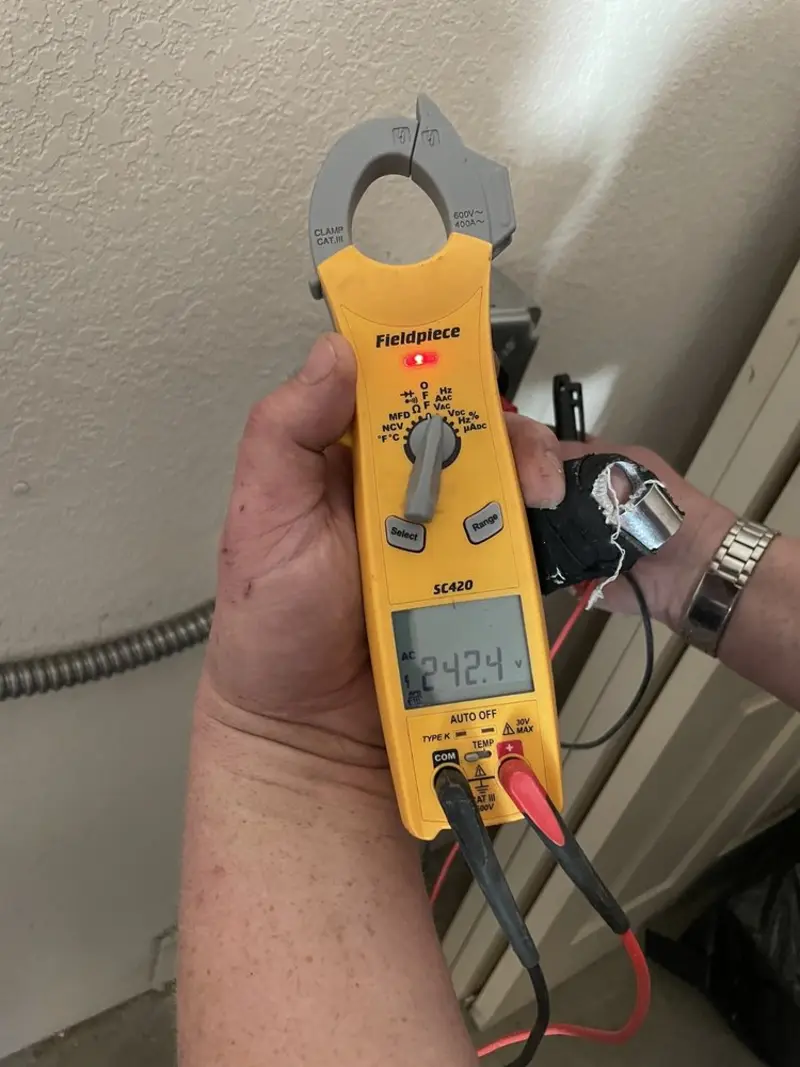 Voltage testing with clamp meter during Electrical Installation Services in Phelps
